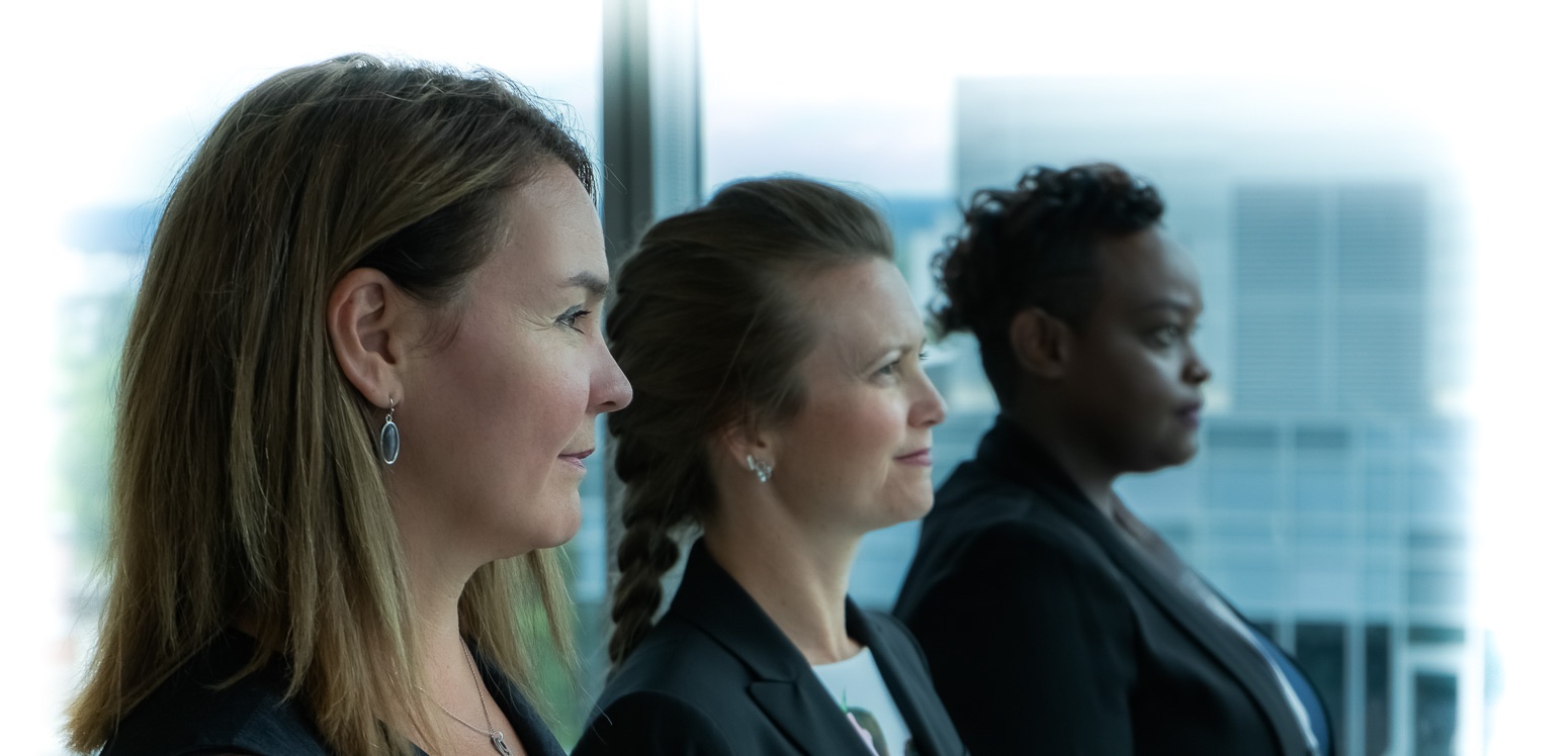 The Commissioner and 2 woman looking at window